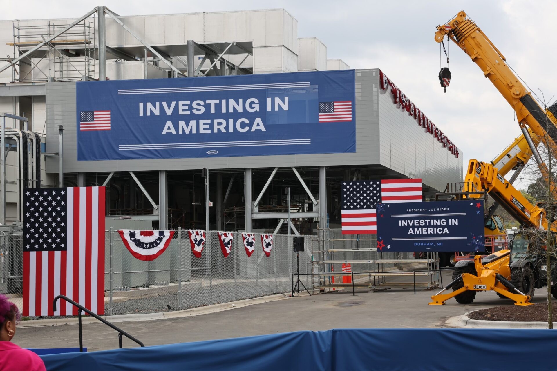 Invest in America banner hung over a building on the Wolfspeed campus in preparation for President Biden's visit.