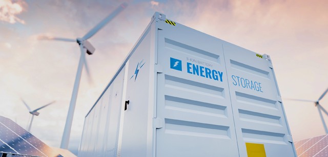 Image of a large industrial energy storage system with windmills and the sky and clouds in the background.