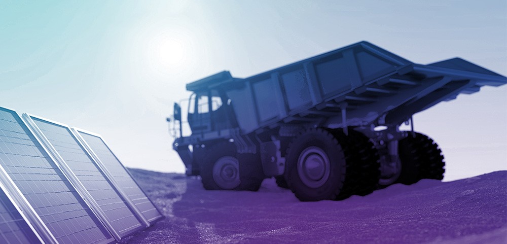 An image of a commercial dump truck with a blue-purple gradient filter over top. This represents Wolfspeed's products that support e-mobility projects on land.