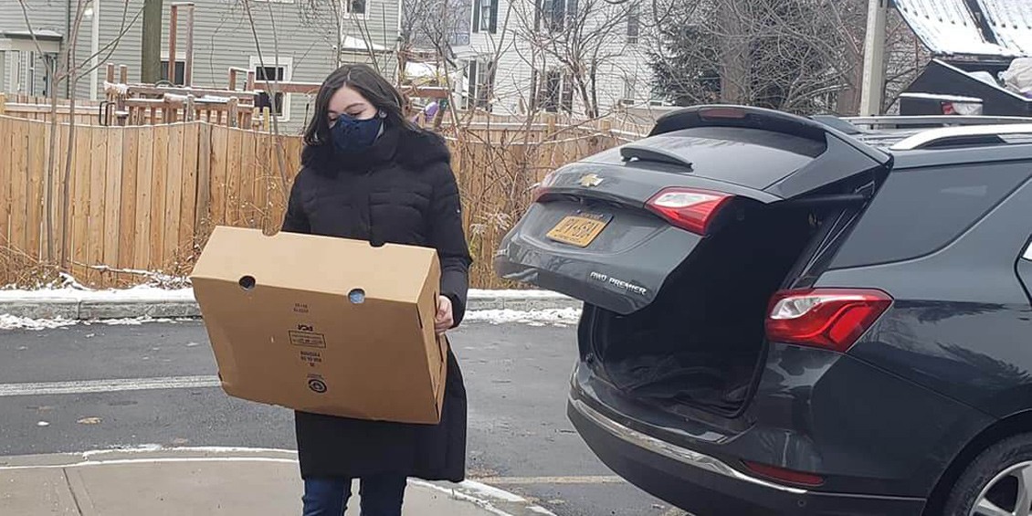 Serving families in need, Anastasia Fasca helps deliver turkeys to the Rescue Mission of Utica.