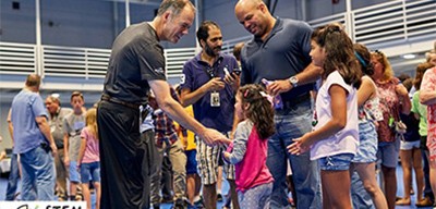 Gregg Lowe, CEO, greets a child during a STEM day at Wolfspeed.