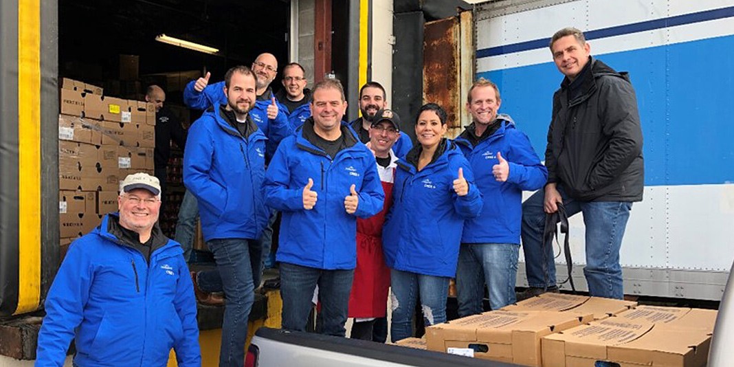 Group photo of a Wolfspeed team, who donated 200 turkeys and holiday baskets to the Utica Rescue Mission for families in need.