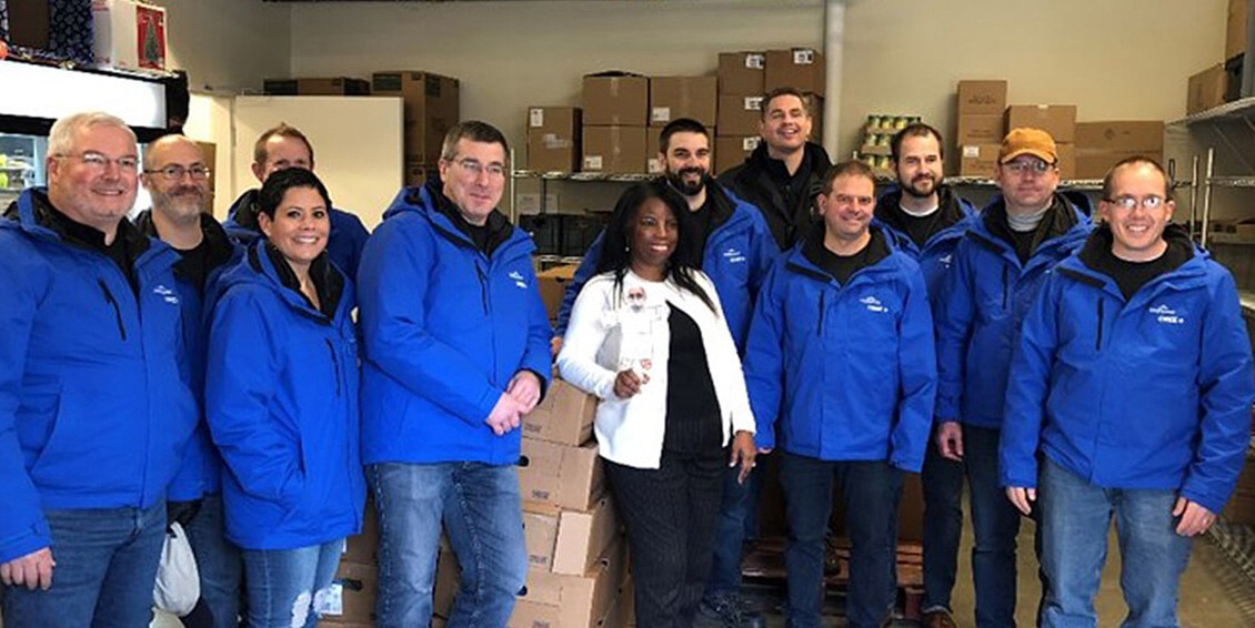 A group of Wolfspeed volunteers taking a photo together after donating food to Utica Mission in Utica New, York.