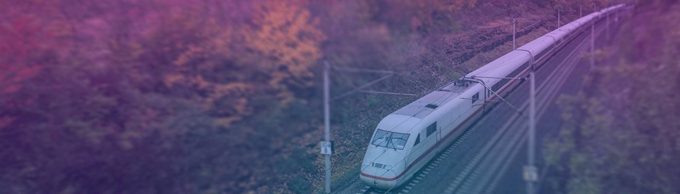 An electric train crosses through the woods representing how Wolfspeed’s Silicon Carbide solutions run more efficiently and reliably than silicon products.