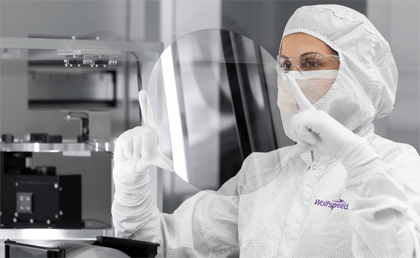 Wolfspeed materials technician holding a 300mm wafer.